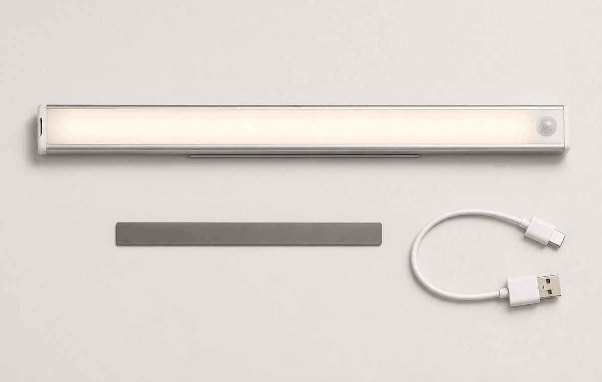 Dwellio motion sensor light inside a kitchen cabinet illuminating stacked plates, bowls and wine glasses